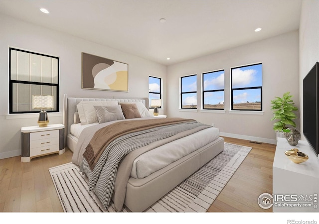 bedroom with light hardwood / wood-style floors