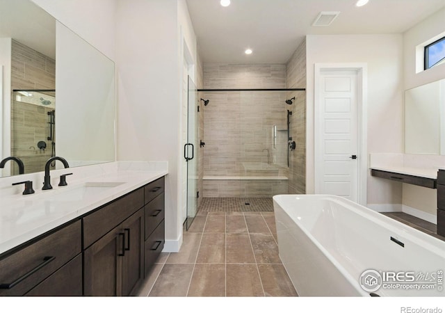 bathroom featuring vanity, independent shower and bath, and tile patterned flooring