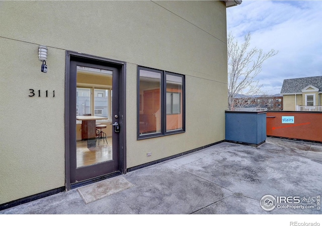 property entrance with a patio area