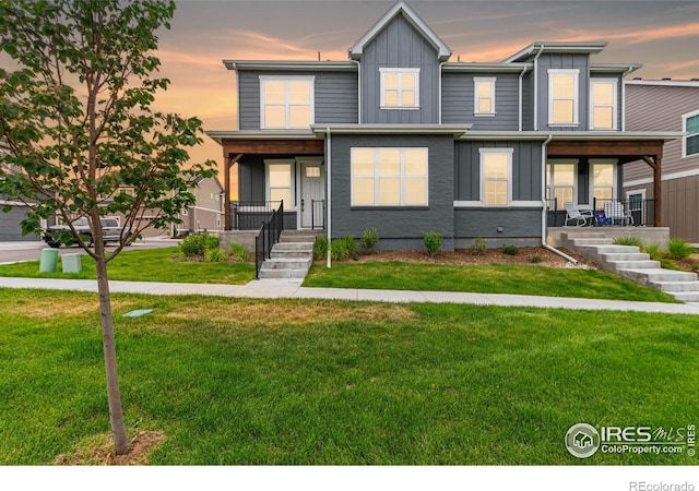 view of front of property with a lawn and a porch