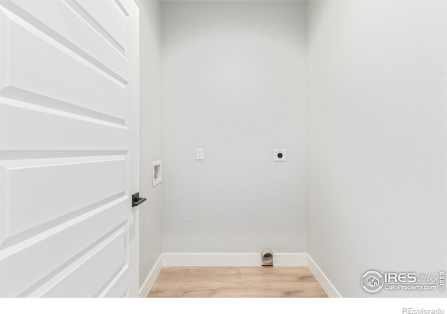 clothes washing area with hookup for a washing machine, light hardwood / wood-style flooring, and hookup for an electric dryer