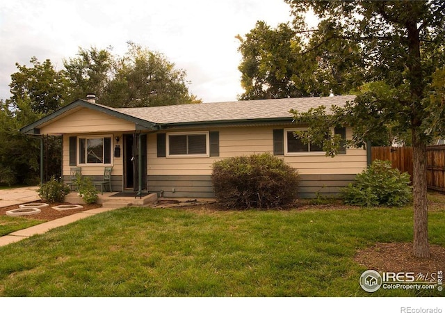 ranch-style home featuring a front yard