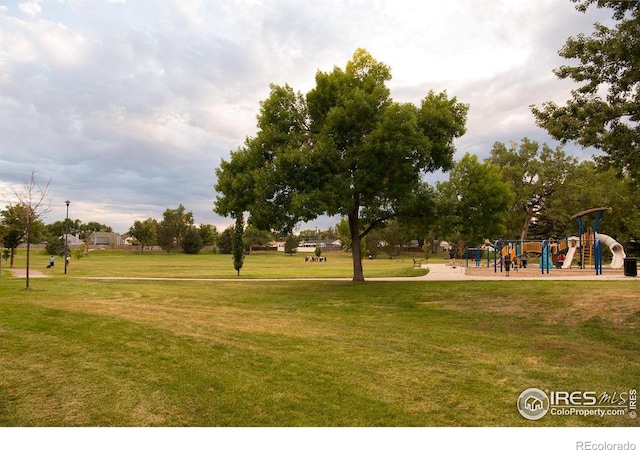 view of home's community with playground community and a lawn