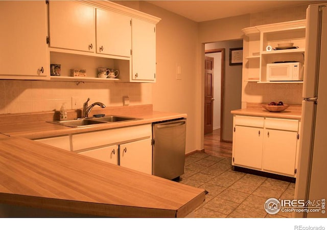 kitchen featuring white appliances, open shelves, a sink, and light countertops