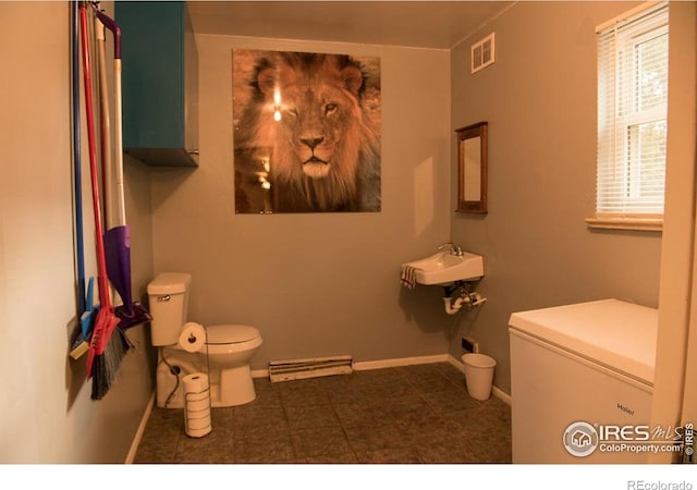 bathroom featuring toilet, baseboards, visible vents, and a sink