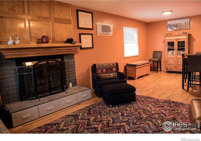 6213 Gray St, Arvada, CO 80003 - living area with a brick fireplace, wood finished floors, and a wall unit AC