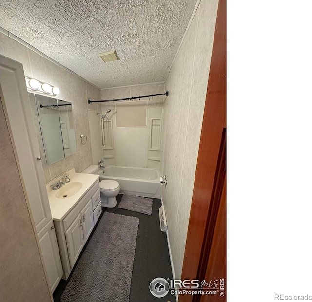 6213 Gray St, Arvada, CO 80003 - full bathroom featuring a textured ceiling, toilet, tub / shower combination, and vanity