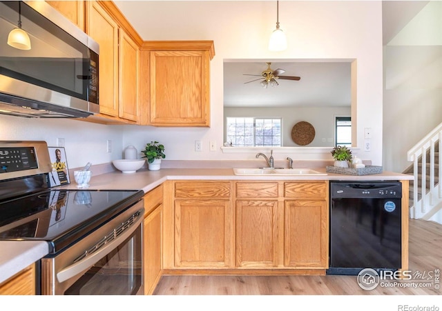 kitchen featuring appliances with stainless steel finishes, ceiling fan, pendant lighting, and sink