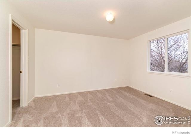 spare room with light colored carpet