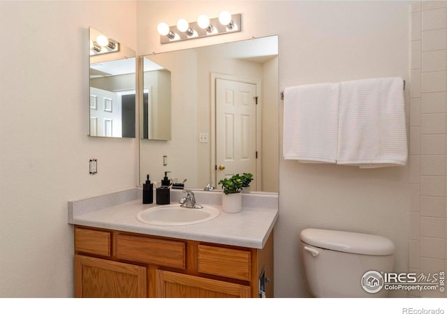 bathroom featuring vanity and toilet