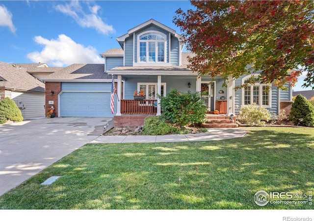 view of front of property with a front yard, a porch, and a garage