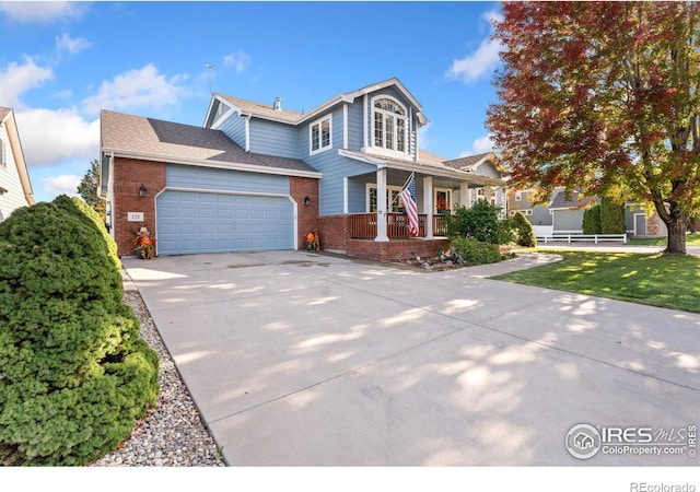 view of front property with a porch and a garage