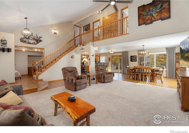 living room with ceiling fan, high vaulted ceiling, and light hardwood / wood-style flooring