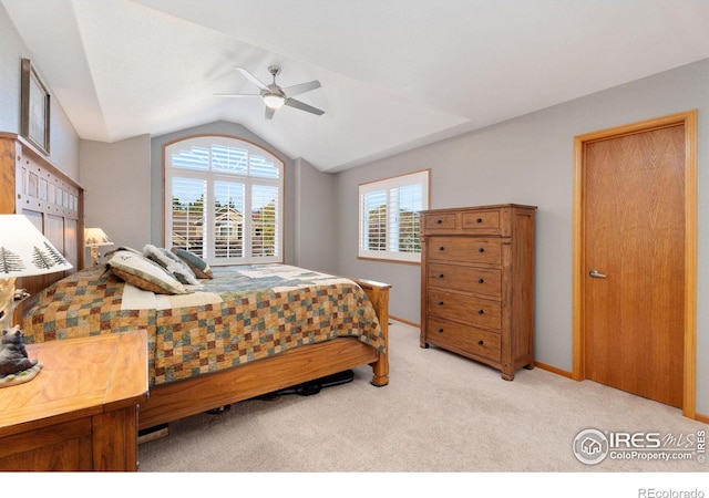 bedroom featuring ceiling fan, light carpet, and vaulted ceiling