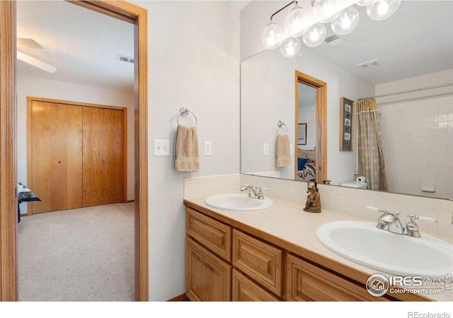 bathroom featuring vanity, toilet, and walk in shower