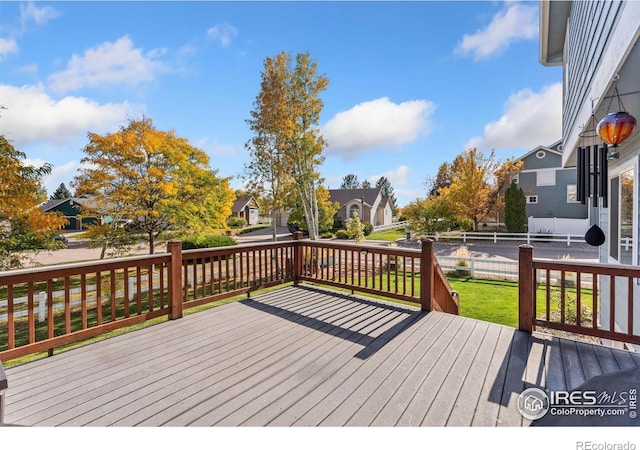 wooden terrace with a yard