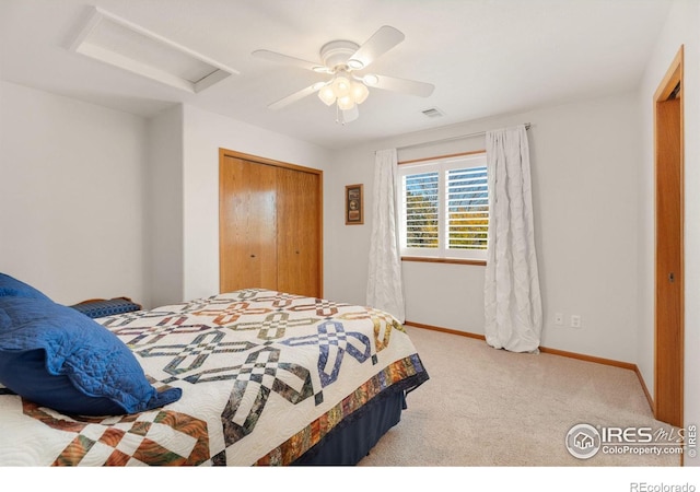 bedroom featuring ceiling fan, a closet, and light carpet