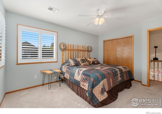 carpeted bedroom with ceiling fan and a closet