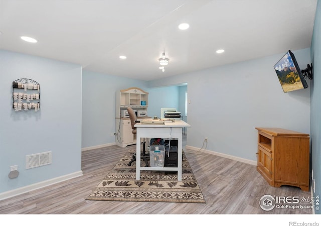 office area with light hardwood / wood-style floors