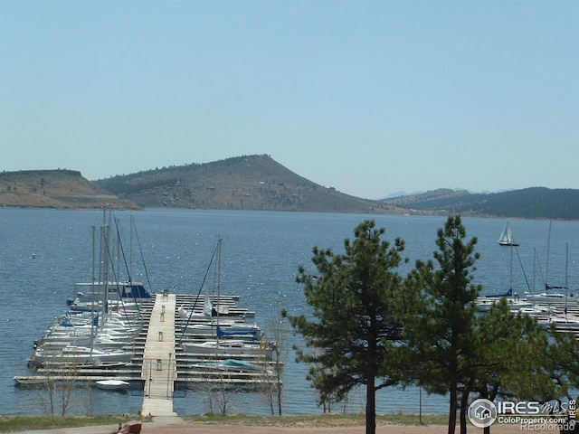 dock area featuring a water and mountain view