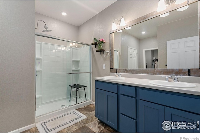 bathroom with vanity and a shower with door