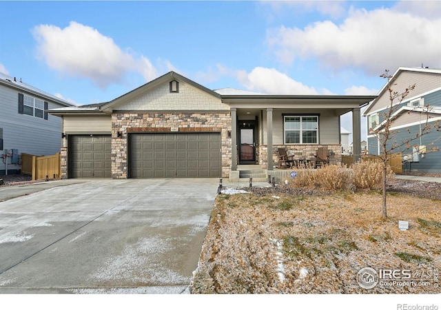 view of front of property featuring covered porch and a garage