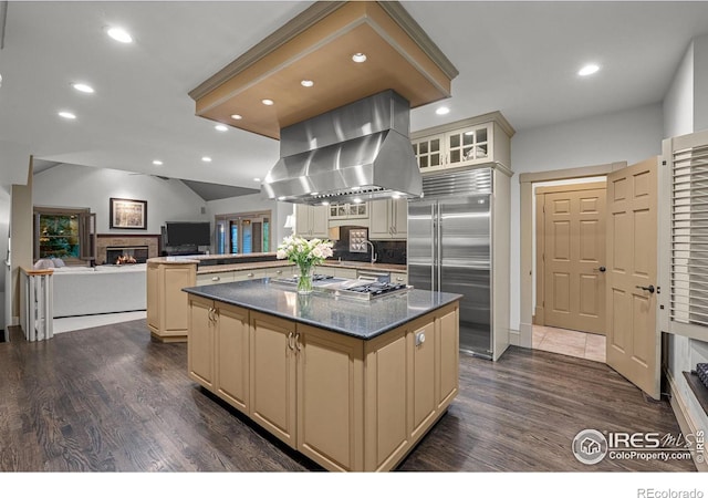 kitchen featuring island exhaust hood, cream cabinetry, a center island, and stainless steel appliances