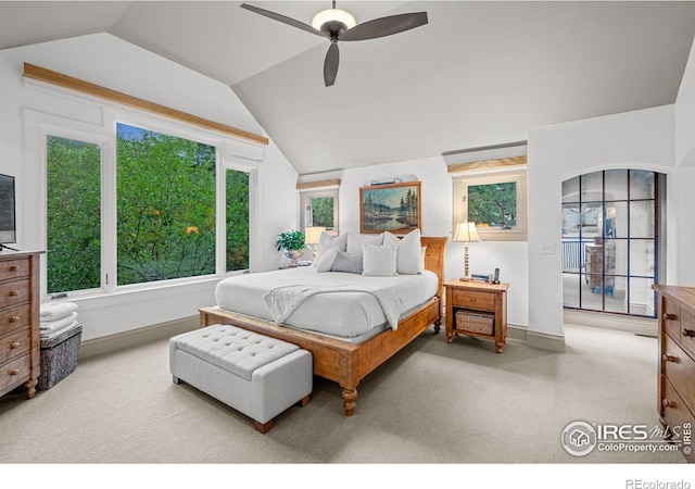 carpeted bedroom with vaulted ceiling and ceiling fan