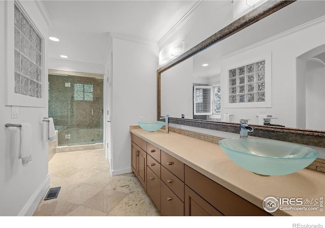 bathroom featuring crown molding, a shower with door, and vanity