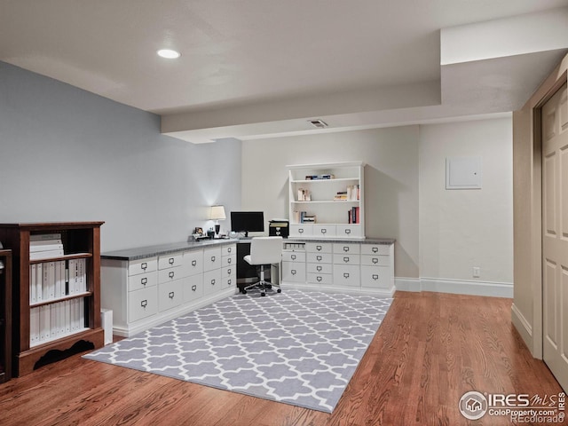 office area with built in desk and light hardwood / wood-style flooring