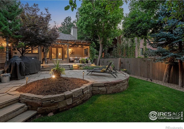 yard at dusk with a patio