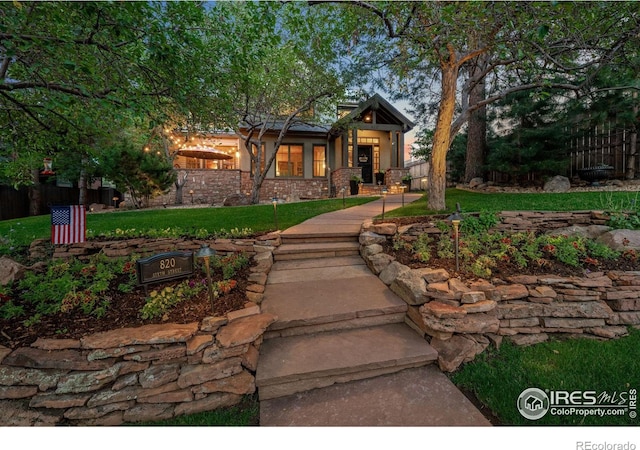 view of front of house with a front yard and fence