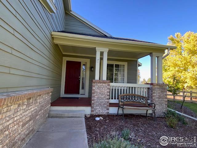 view of exterior entry featuring covered porch