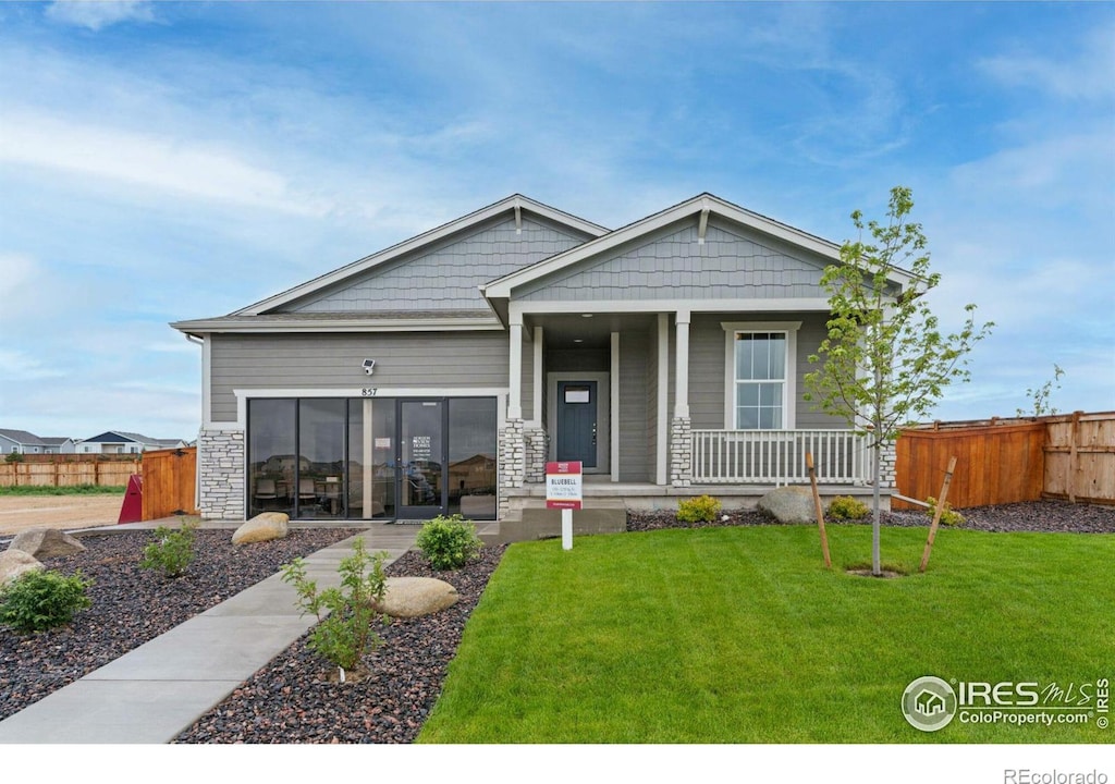 craftsman-style home with a front yard and a porch