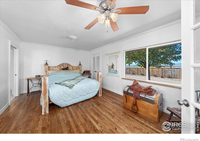 bedroom with ceiling fan, wood-type flooring, and crown molding