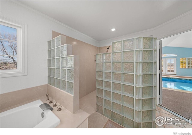 bathroom with ornamental molding and plus walk in shower