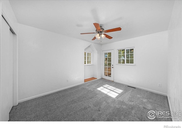 empty room featuring ceiling fan and carpet floors