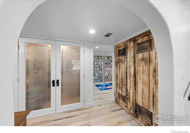 interior space with light hardwood / wood-style flooring and french doors