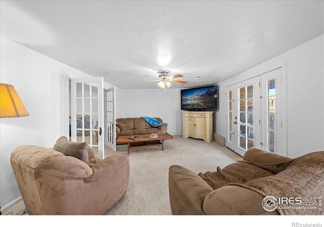 living room with french doors, light colored carpet, and ceiling fan