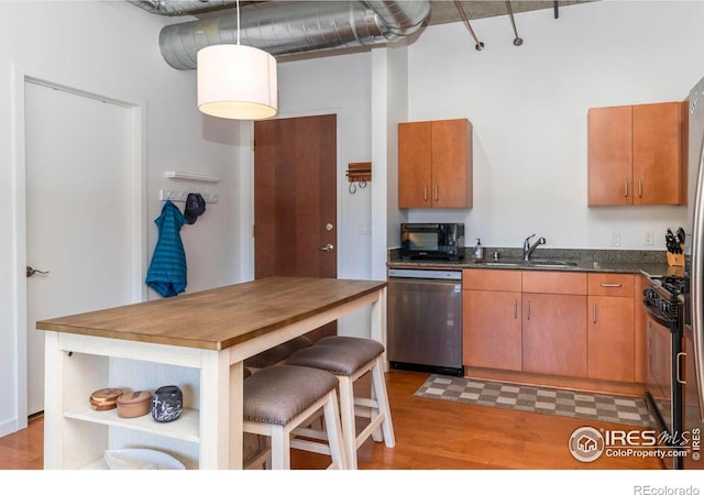 kitchen featuring sink, stainless steel appliances, and light wood-type flooring