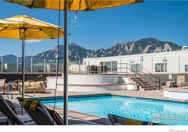 view of swimming pool with an outdoor hangout area, a mountain view, and a patio