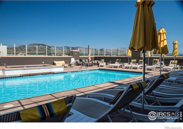 view of swimming pool with a mountain view and a patio area