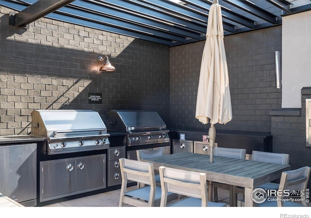 view of patio with an outdoor kitchen and grilling area