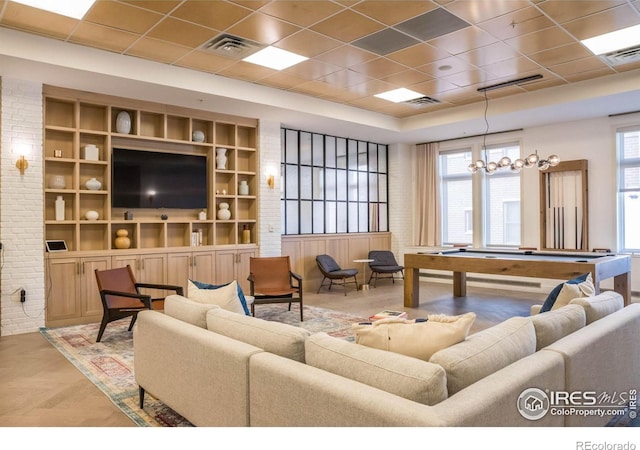 living room featuring pool table, a paneled ceiling, built in features, and light parquet flooring