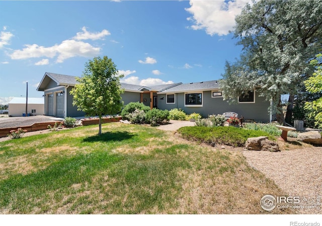 view of front of property with a garage and a front yard