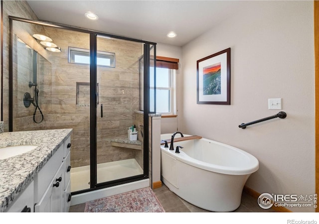 bathroom featuring vanity and separate shower and tub