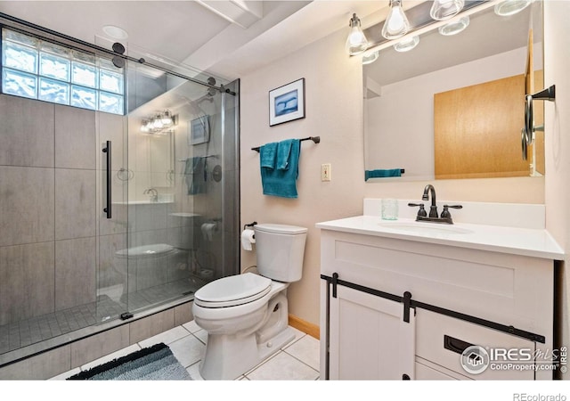 bathroom with tile patterned floors, toilet, a shower with door, and vanity