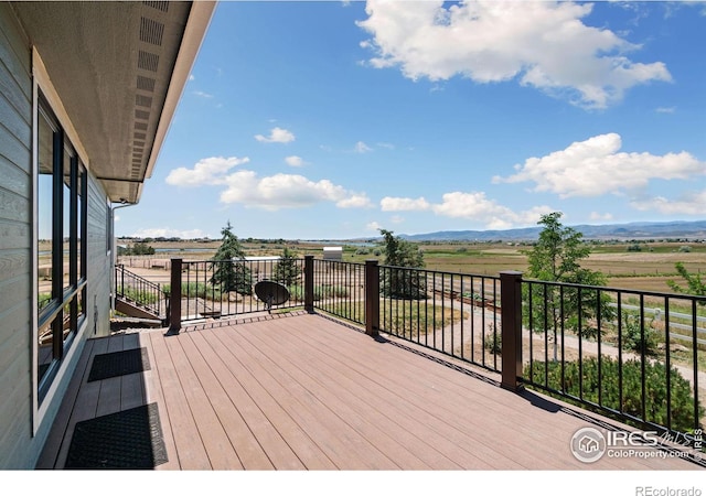 wooden terrace featuring a rural view