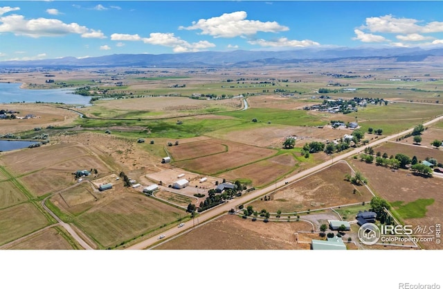 aerial view with a water and mountain view and a rural view