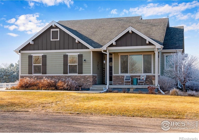 craftsman-style house with covered porch and a front lawn